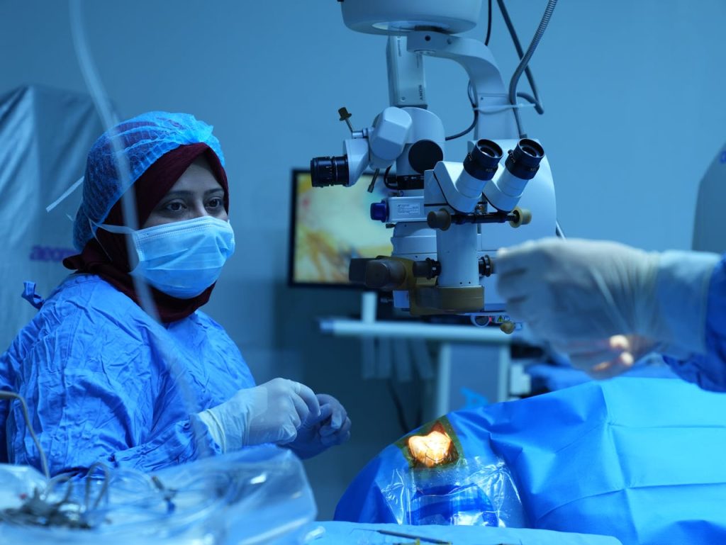 A surgeon operates using advanced medical equipment during a precise eye surgery procedure.