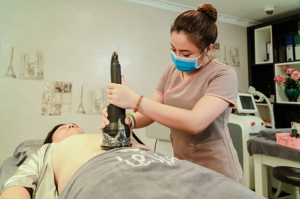 A spa therapist performs laser treatment at a salon, ensuring relaxation and rejuvenation.